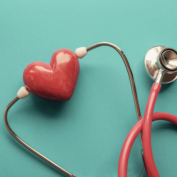 Red stethoscope with red stone heart carving