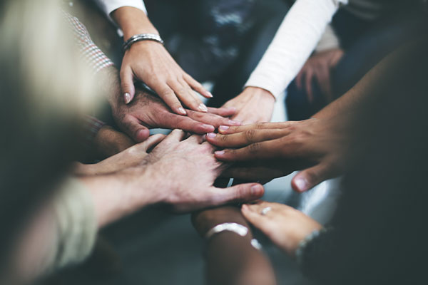 Group of hands together in a circle