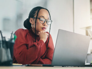 Professional, thoughtful person at laptop